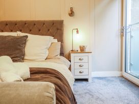 A bedroom with a bed and nightstand at Hafod Y Bryn in Harlech