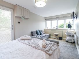 A bedroom with a bed and a sofa at Hafod Y Bryn in Harlech