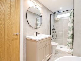 A bathroom with a sink and shower at Hafod Y Bryn in Harlech