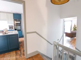 A staircase leading to a kitchen area at Island House in Aberaeron