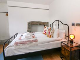 A bedroom with a bed and nightstand at Island House in Aberaeron