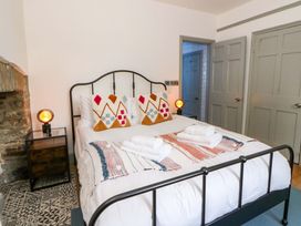 A bedroom with a bed and bedside table at Island House in Aberaeron