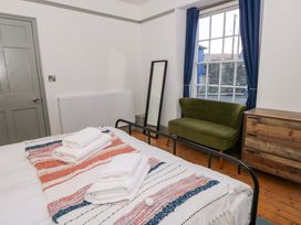 A bedroom with a bed and towels on it at Island House in Aberaeron