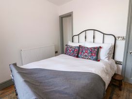 A bedroom with a bed and pillows at Island House in Aberaeron