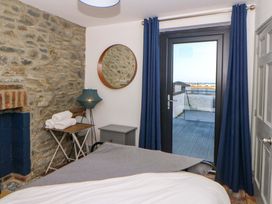A bedroom with a bed and a mirror at Island House in Aberaeron