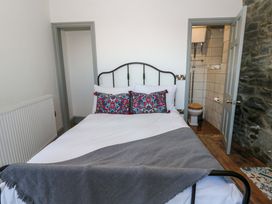 A bedroom with a bed and an ensuite bathroom at Island House Aberaeron