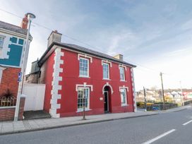 A red building with windows and a door at Island House in Aberaeron