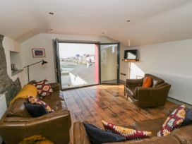 A living room with a sofa and armchair at Island House in Aberaeron