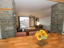 A living room with a sofa and table at Island House in Aberaeron