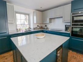 A kitchen with cabinets and a countertop at Island House Aberaeron