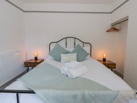 A bedroom with a bed and bedside tables at Island House Aberaeron