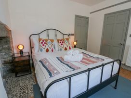 A bedroom with a bed and bedside table at Island House in Aberaeron