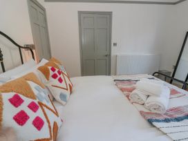 A bedroom with a bed and pillows at Island House in Aberaeron
