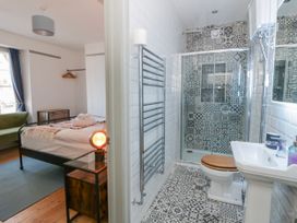 A bathroom with a shower and toilet adjoining a bedroom at Island House in Aberaeron