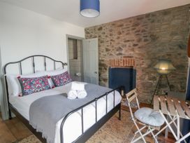 A bedroom with a bed and a table at Island House in Aberaeron