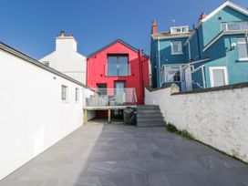 A house with a red building and balcony in an outdoor area at Island House Aberaeron