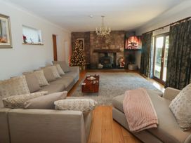 A living room with a fireplace and sofa at Brookway Lodge Caerwys