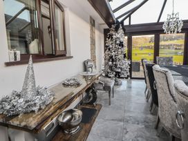 A dining room with a Christmas tree and table at Brookway Lodge in Caerwys