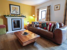 A living room with a sofa and coffee table at Brookway Lodge in Caerwys