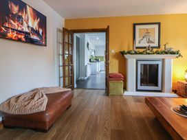 A living room with a fireplace and television at Brookway Lodge in Caerwys