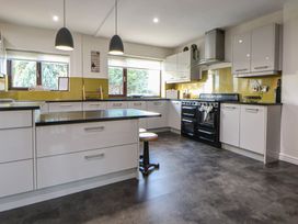 A kitchen with a black oven and countertop at Brookway Lodge in Caerwys