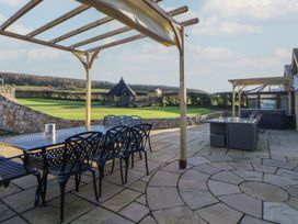 An outdoor space with a table and chairs at Brookway Lodge Caerwys