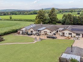 A house with a garden and patio at Brookway Lodge in Caerwys