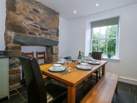 A dining room with a table set for a meal at Ty Capel Bethania in Nant Gwynant