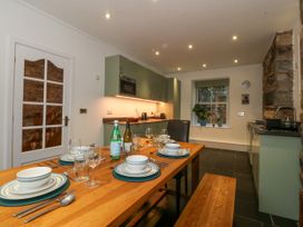 A kitchen with a dining table set at Ty Capel Bethania in Nant Gwynant