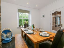 A dining room with a table set for a meal at Ty Capel Bethania Nant Gwynant