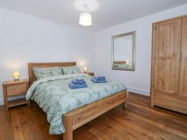 A bedroom with a bed and wardrobe at Ty Capel Bethania in Nant Gwynant