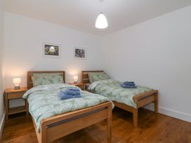 A bedroom with two beds and bedside tables at Ty Capel Bethania Nant Gwynant