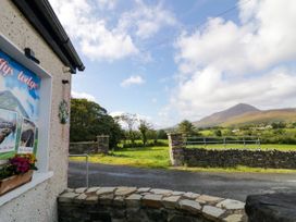 The exterior view featuring a sign and mountains at Duffy Lodge in Kilmacloo near Creeslough, County Donegal