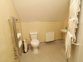 A bathroom with a toilet and sink at Duffy Lodge Kilmacloo near Creeslough County Donegal