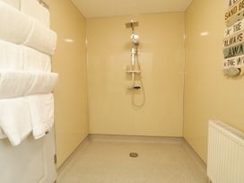 A bathroom with a shower and towels at Duffy Lodge in Kilmacloo near Creeslough, County Donegal