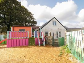 An outdoor area with a house and playhouse at Duffy Lodge in Kilmacloo near Creeslough, County Donegal