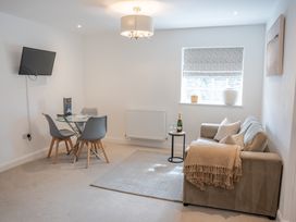 A living room with a sofa and dining area at Ullswater in Ulverston