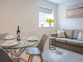 A dining room with a table and couch at Ullswater in Ulverston