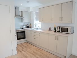 A kitchen with a stove, sink, and appliances at Ullswater in Ulverston