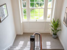 A staircase with a window and plant at Ullswater in Ulverston