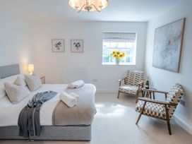 A bedroom with a bed and seating area at Ullswater in Ulverston