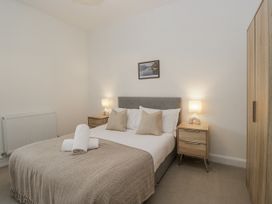 A bedroom with a bed and bedside tables at Ullswater in Ulverston