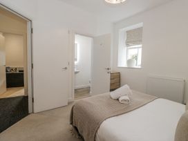 A bedroom with a bed and towels at Ullswater in Ulverston