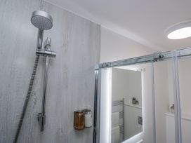 A bathroom with a shower and mirror cabinet at Ullswater in Ulverston