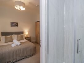 A bedroom with a bed and wardrobe at Ullswater in Ulverston
