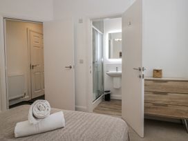 A bedroom with a bed and an ensuite bathroom at Ullswater in Ulverston