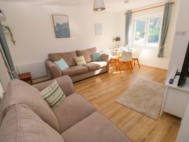 A living room with a sofa and dining area at No.22 The Clicketts in Tenby
