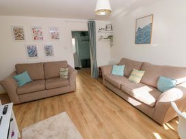 A living room with two sofas and wall art at No.22 The Clicketts in Tenby