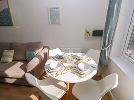 A dining area with a table set for four at No.22 The Clicketts Tenby