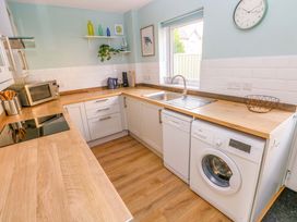 A kitchen with a sink and appliances at No.22 The Clicketts Tenby